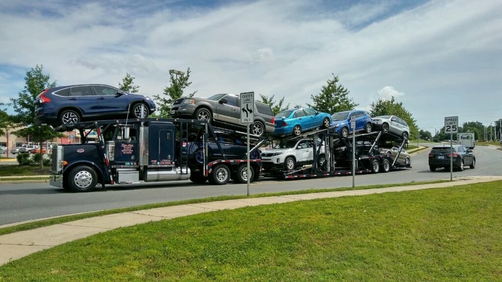 An Open Car Transport Carrier with a full load of cars. Cheapest way to ship a car.