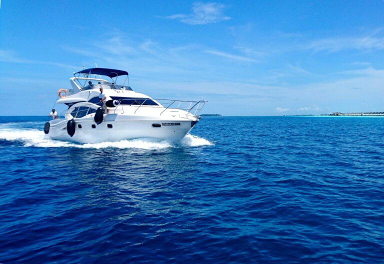 White motor yacht cruising on open blue water