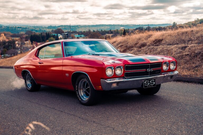 Red Chevrolet Chevelle SS classic muscle car on a country road