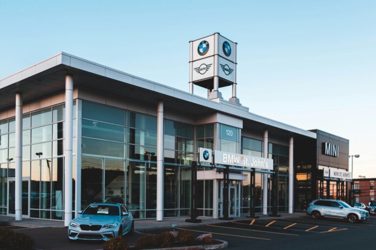 Car dealership showroom with new cars parked out front